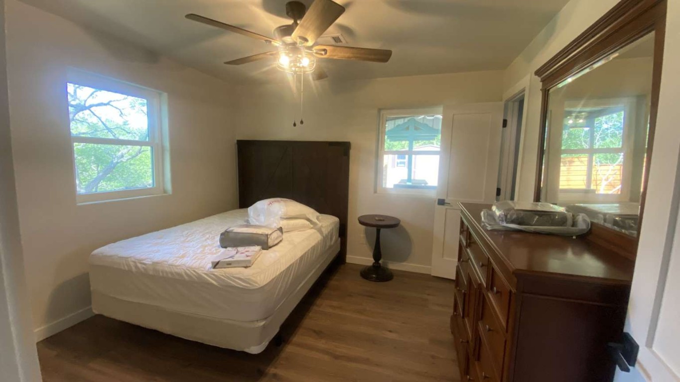 1202 Nix Road Lampasas, TX 76550 - Photo 14 of 20 Bedroom featuring dark wood-type flooring and a ceiling fan