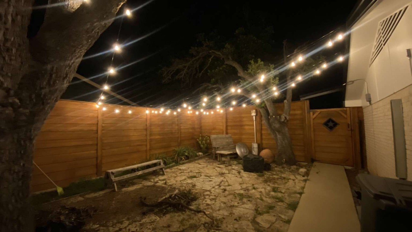 1202 Nix Road Lampasas, TX 76550 - Photo 18 of 20 Patio at night featuring a fenced backyard and a gate
