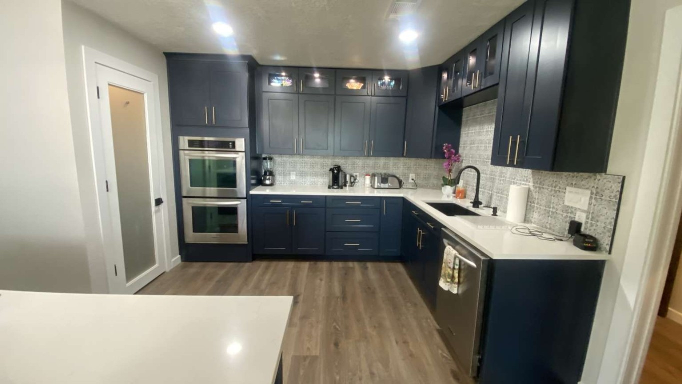 1202 Nix Road Lampasas, TX 76550 - Photo 4 of 20 Kitchen with dark wood-style flooring, glass insert cabinets, appliances with stainless steel finishes, tasteful backsplash, and recessed lighting