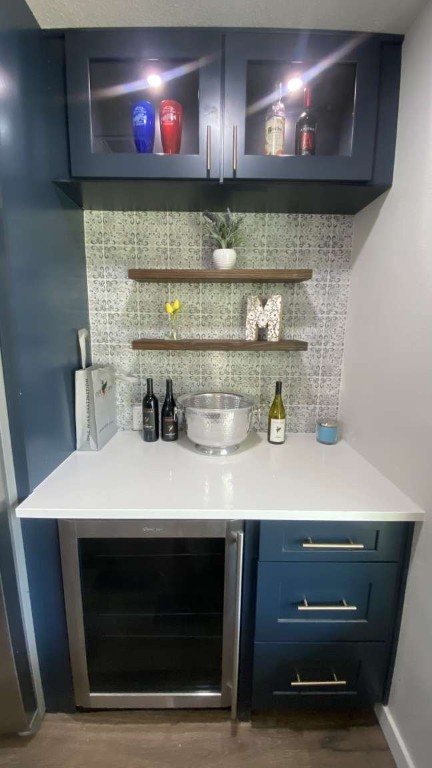 1202 Nix Road Lampasas, TX 76550 - Photo 5 of 20 Indoor dry bar with beverage cooler, blue cabinets, backsplash, and open shelves