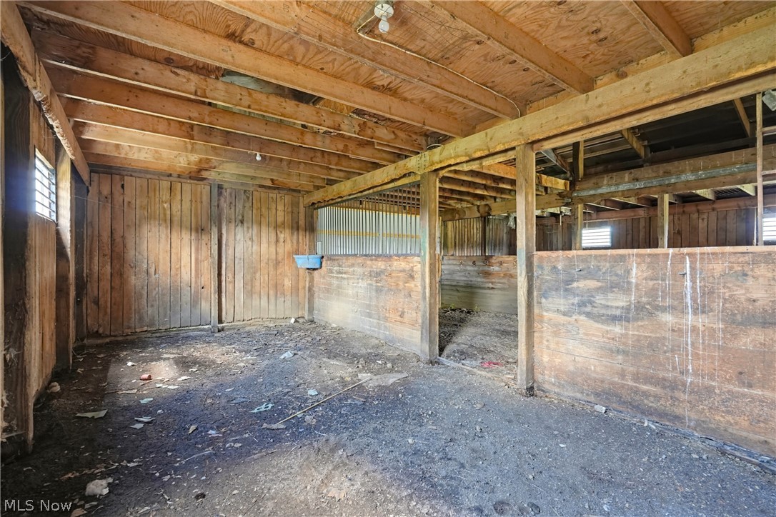 82 State Route Newton Falls, OH 44444 - Photo 16 of 30 Barn structure featuring exposed wood beams, wood plank walls, and partitioned stalls