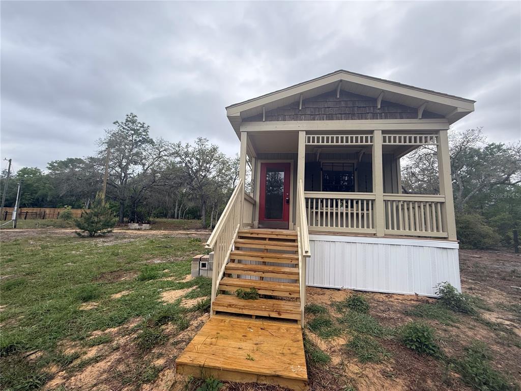 8330 Northeast 100th Avenue Bronson, FL 32621 - Photo 16 of 17 a view of a house with a yard