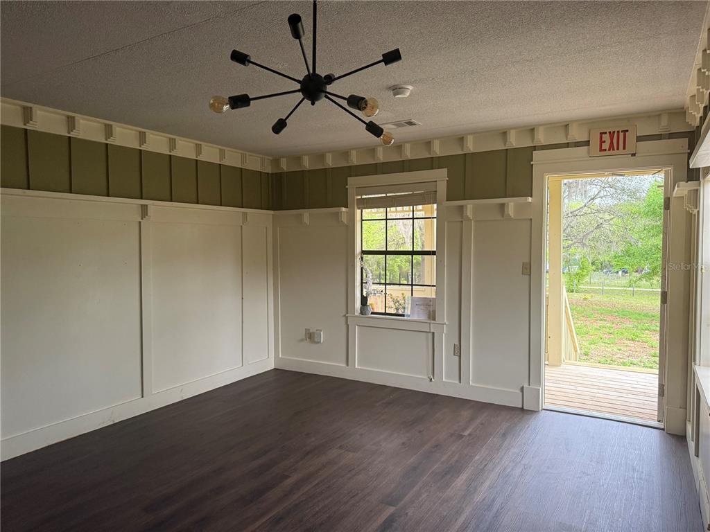 8330 Northeast 100th Avenue Bronson, FL 32621 - Photo 4 of 17 a view of empty room with wooden floor and fan