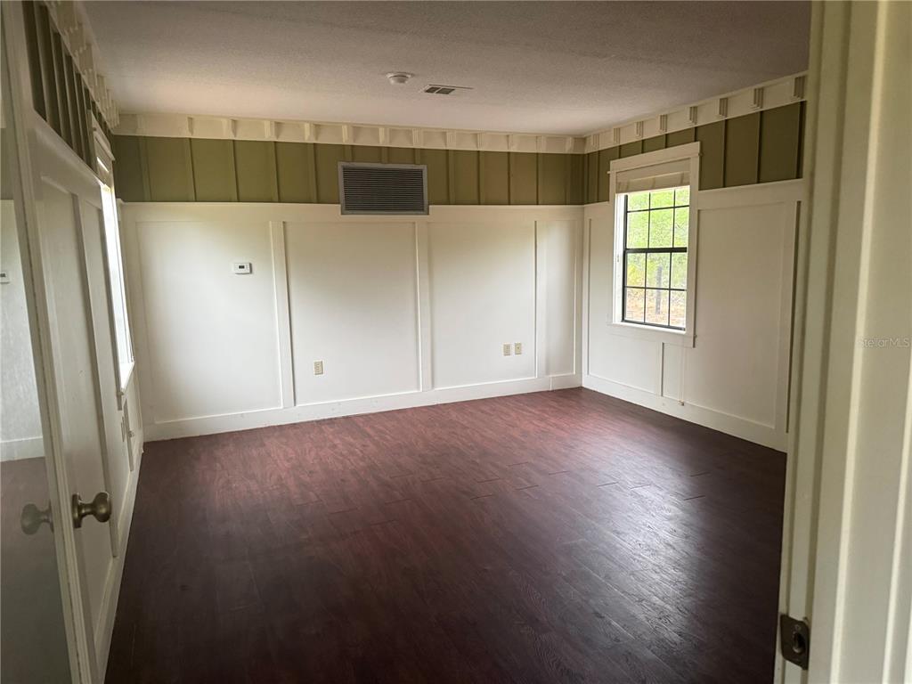 8330 Northeast 100th Avenue Bronson, FL 32621 - Photo 6 of 17 a view of hallway with window and wooden cabinets