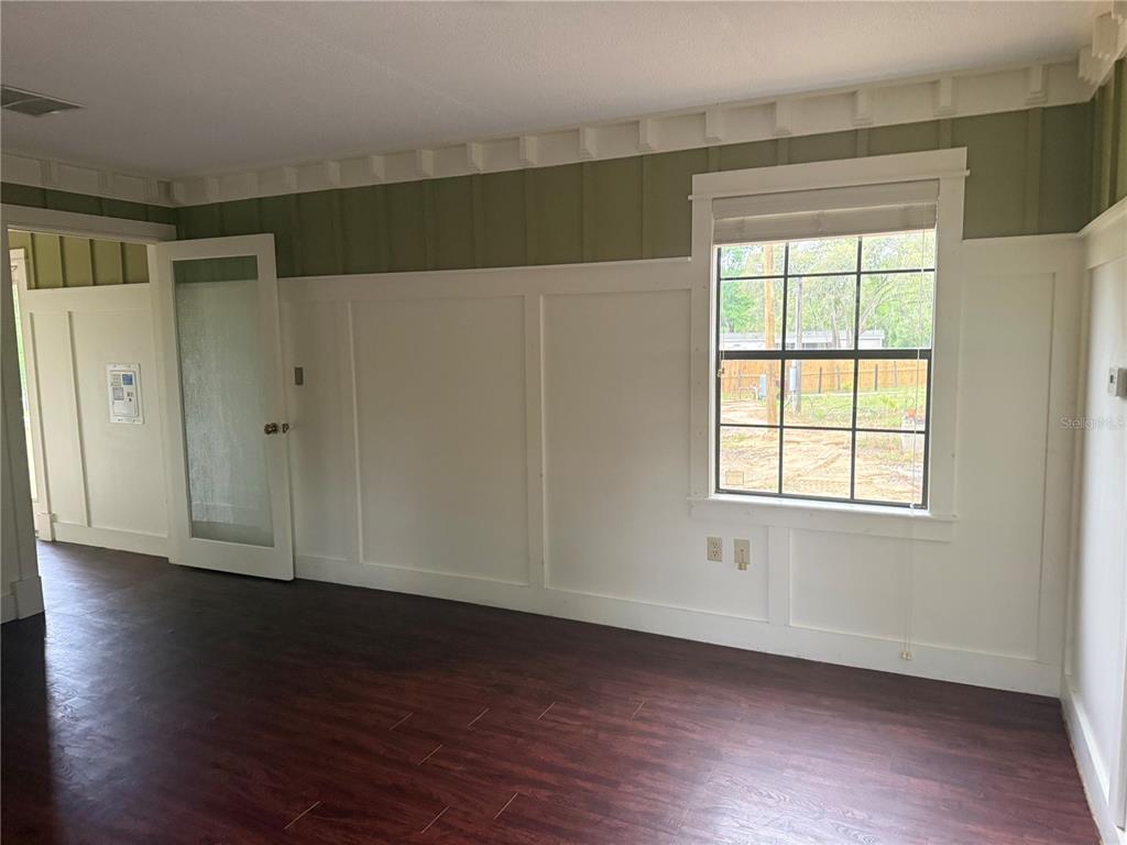 8330 Northeast 100th Avenue Bronson, FL 32621 - Photo 9 of 17 a view of an empty room with wooden floor and a window
