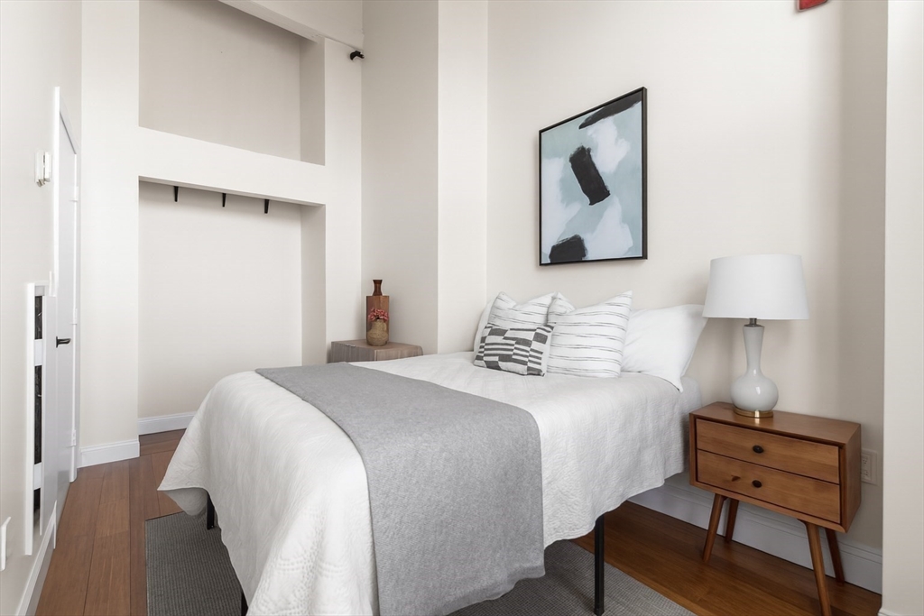 320 West 2nd Street, Unit 502 Boston, MA 02127 - Photo 12 of 21 a bedroom with a bed and a lamp on table