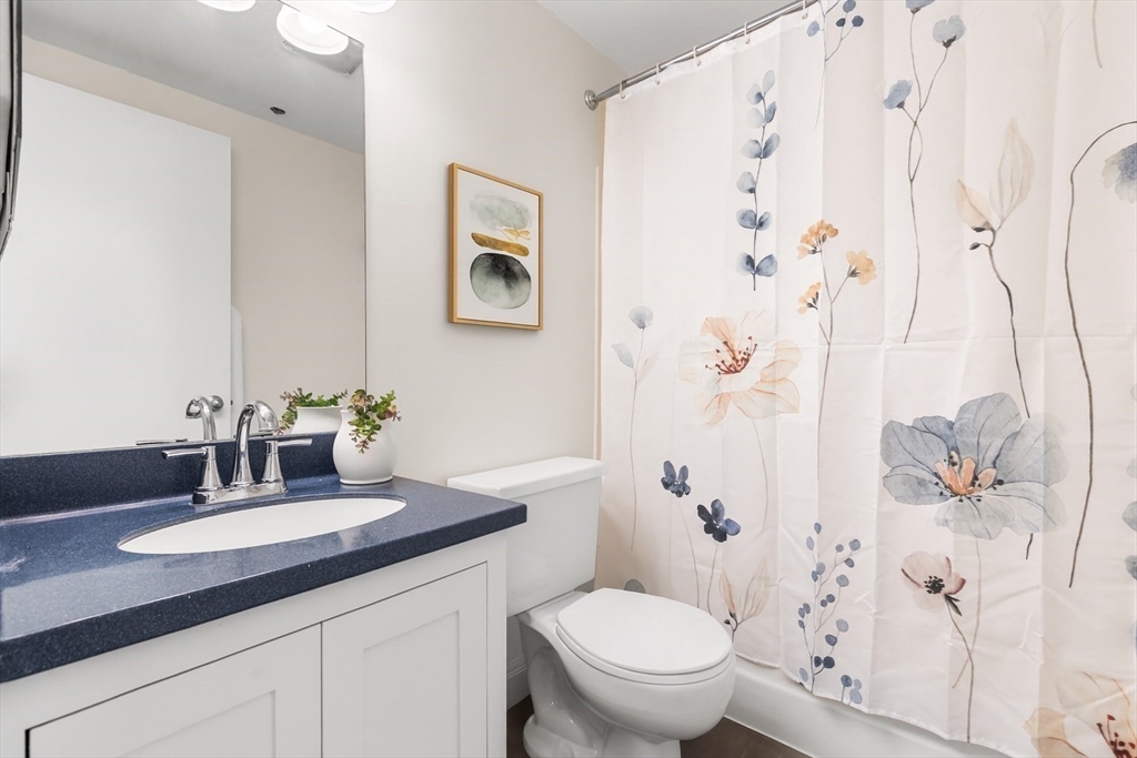 320 West 2nd Street, Unit 502 Boston, MA 02127 - Photo 13 of 21 a bathroom with a granite countertop sink a toilet and a mirror