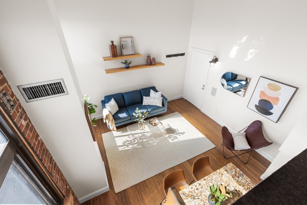 320 West 2nd Street, Unit 502 Boston, MA 02127 - Photo 14 of 21 a living room with furniture and wooden floor