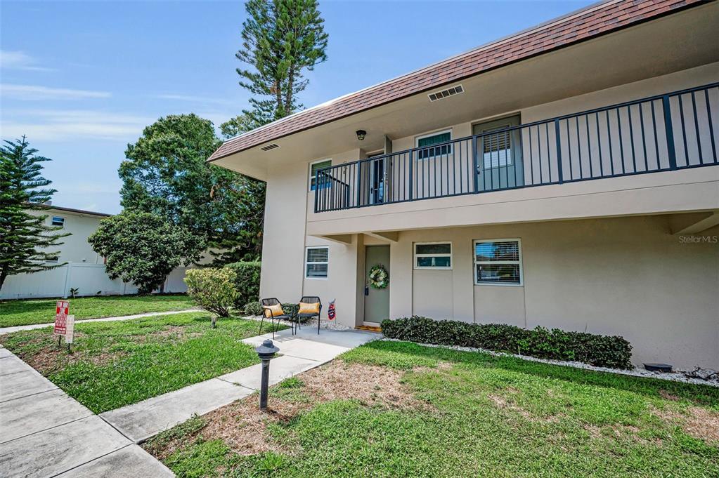 9945 47th Avenue North, Unit 210 St. Petersburg, FL 33708 - Photo 12 of 78 a front view of a house with a yard