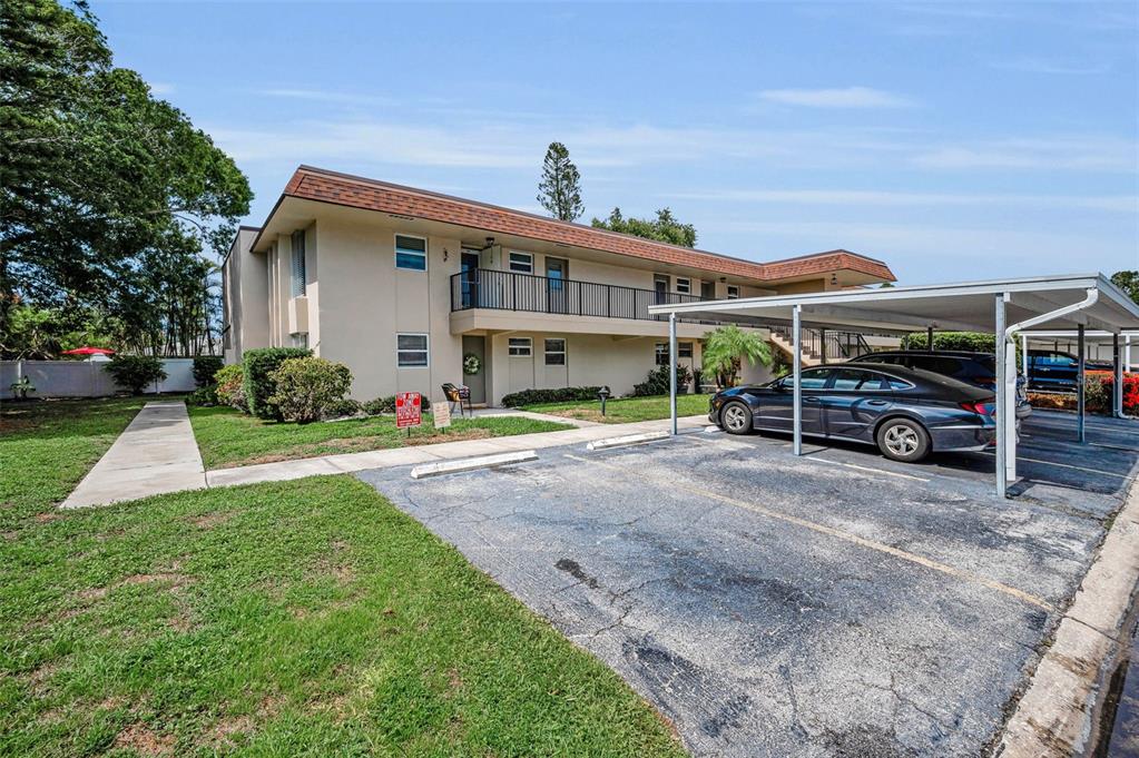 9945 47th Avenue North, Unit 210 St. Petersburg, FL 33708 - Photo 13 of 78 a car parked in front of house