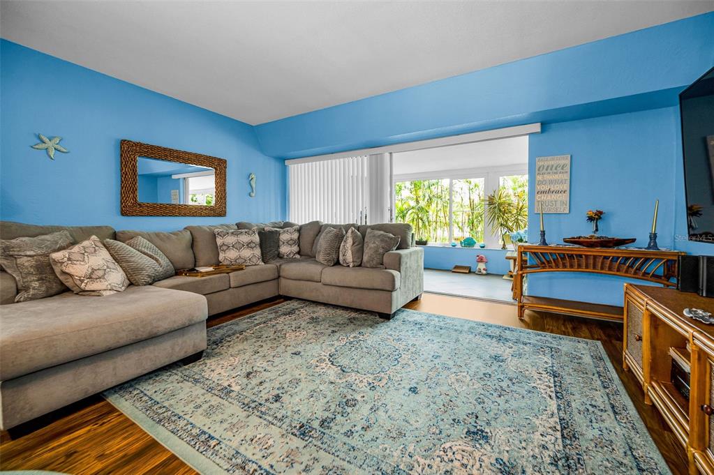 9945 47th Avenue North, Unit 210 St. Petersburg, FL 33708 - Photo 19 of 78 a living room with a couch and a window