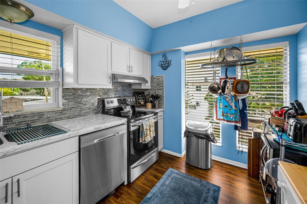 9945 47th Avenue North, Unit 210 St. Petersburg, FL 33708 - Photo 28 of 78 a kitchen with stainless steel appliances granite countertop a sink and a stove