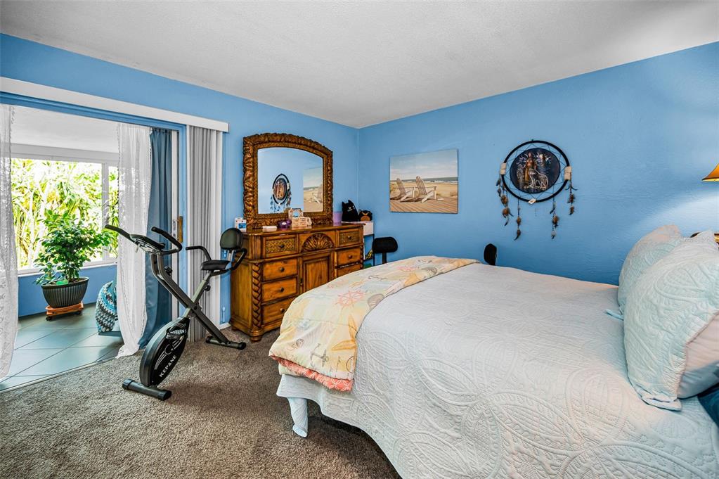 9945 47th Avenue North, Unit 210 St. Petersburg, FL 33708 - Photo 30 of 78 a bedroom with bed and a window