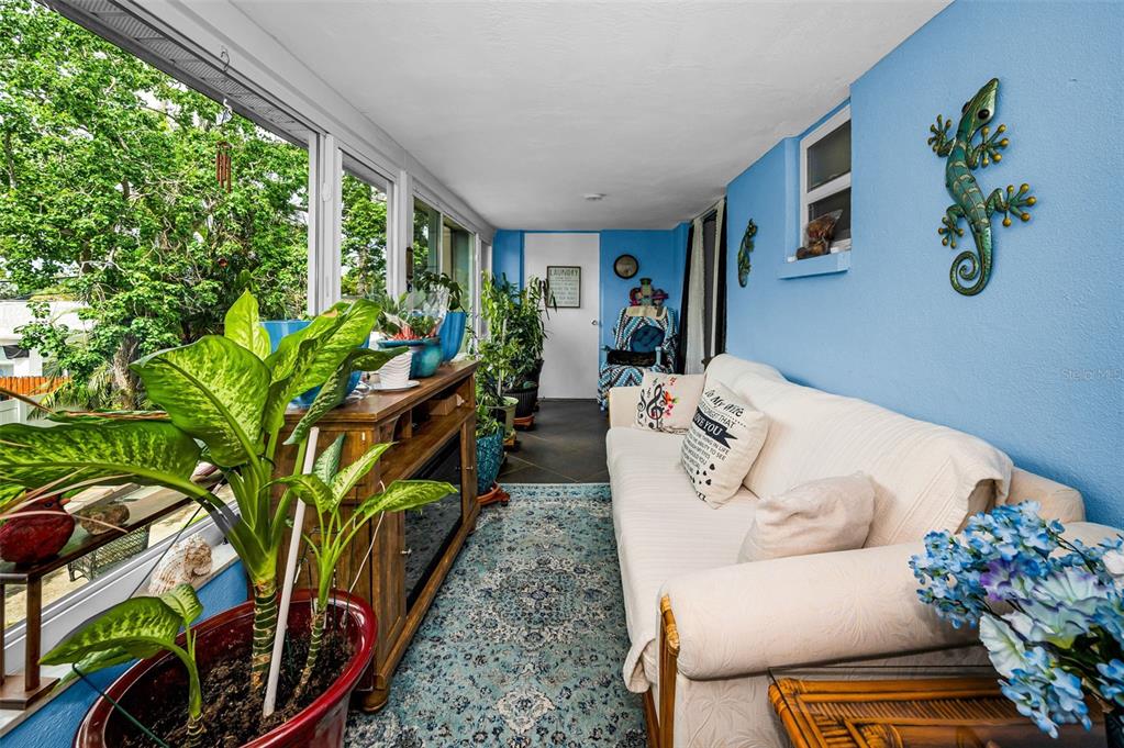 9945 47th Avenue North, Unit 210 St. Petersburg, FL 33708 - Photo 40 of 78 a living room with furniture plant and a large window