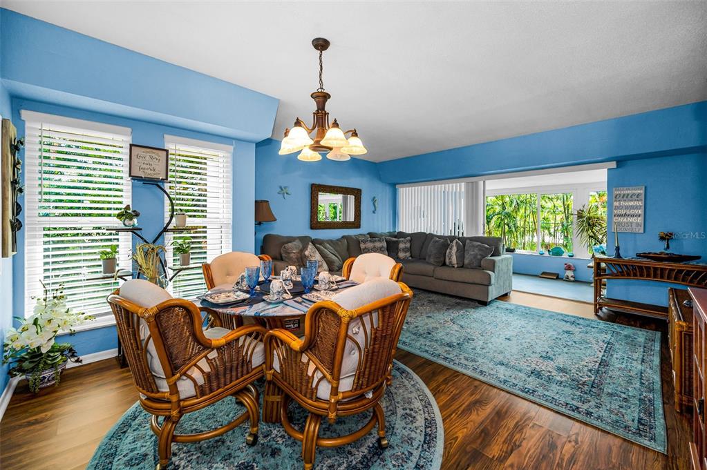 9945 47th Avenue North, Unit 210 St. Petersburg, FL 33708 - Photo 4 of 78 a living room with patio furniture and a chandelier