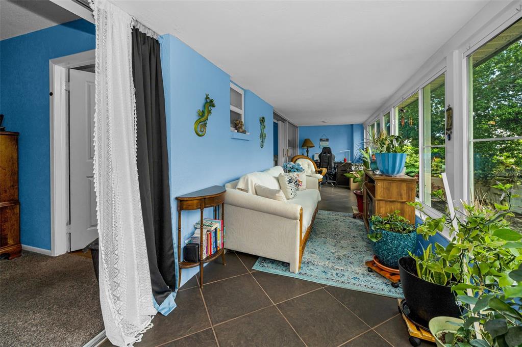 9945 47th Avenue North, Unit 210 St. Petersburg, FL 33708 - Photo 43 of 78 a living room with furniture and a potted plant