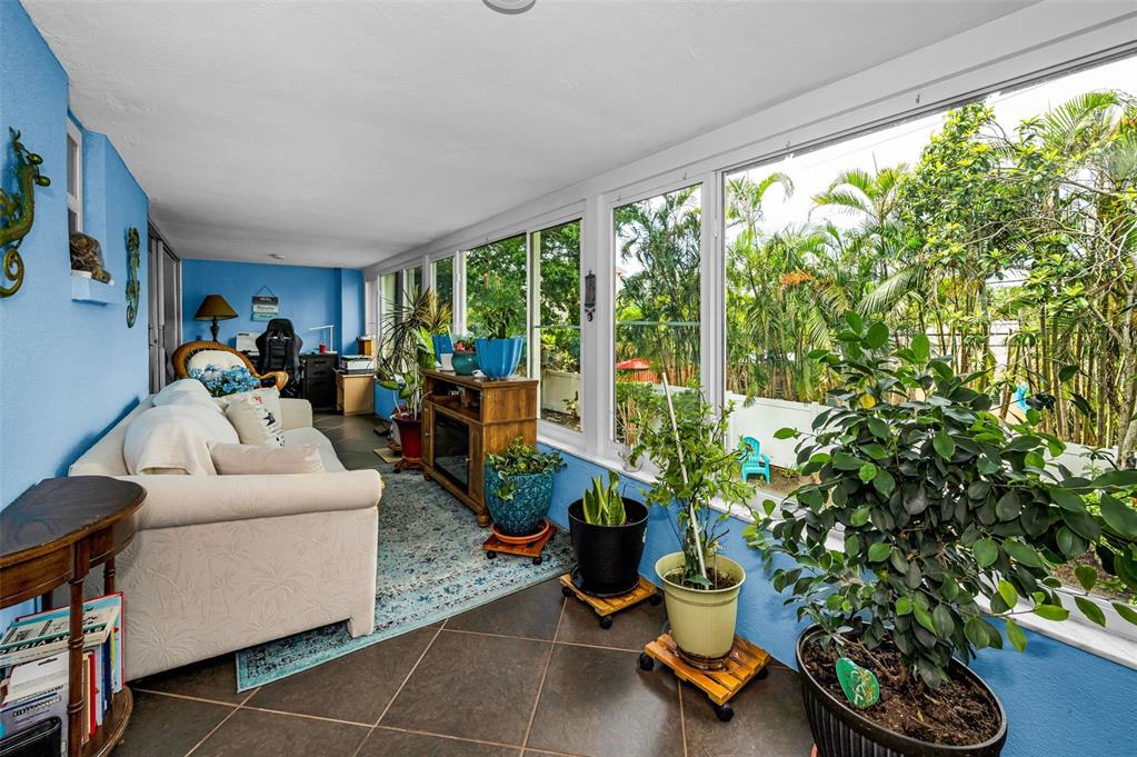 9945 47th Avenue North, Unit 210 St. Petersburg, FL 33708 - Photo 44 of 78 a living room with furniture and a potted plant