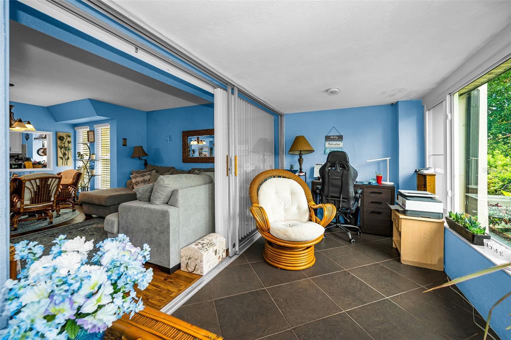 9945 47th Avenue North, Unit 210 St. Petersburg, FL 33708 - Photo 47 of 78 a living room with furniture a rug and a window