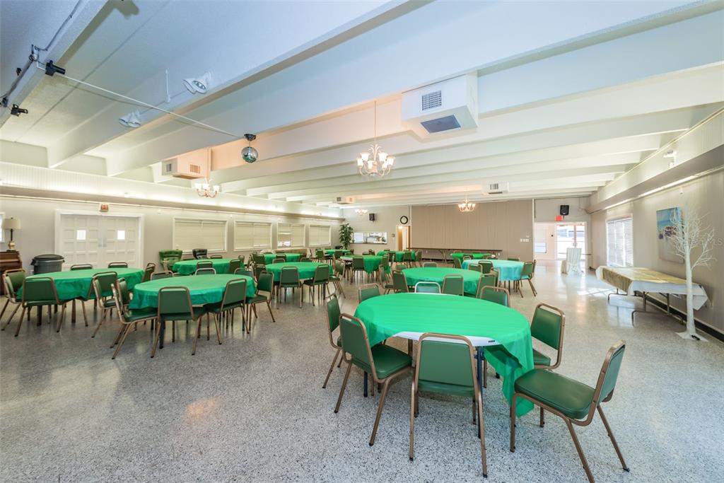 9945 47th Avenue North, Unit 210 St. Petersburg, FL 33708 - Photo 59 of 78 a view of a patio with a dining table and chairs with a garden