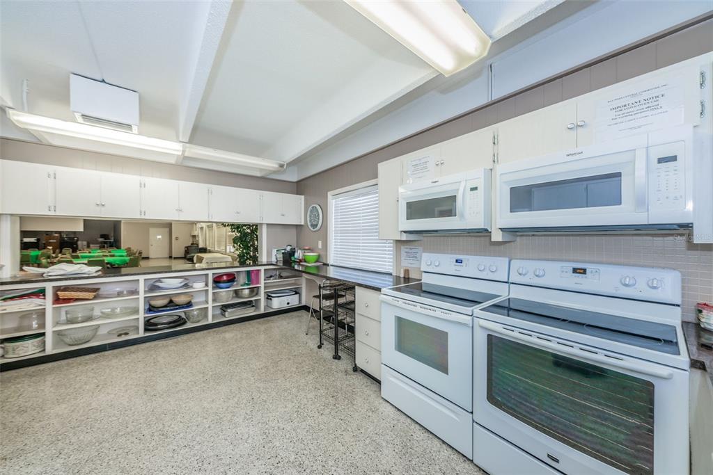 9945 47th Avenue North, Unit 210 St. Petersburg, FL 33708 - Photo 63 of 78 a kitchen with stainless steel appliances a stove sink and cabinets