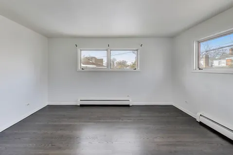 a view of room with stairs and wooden floor