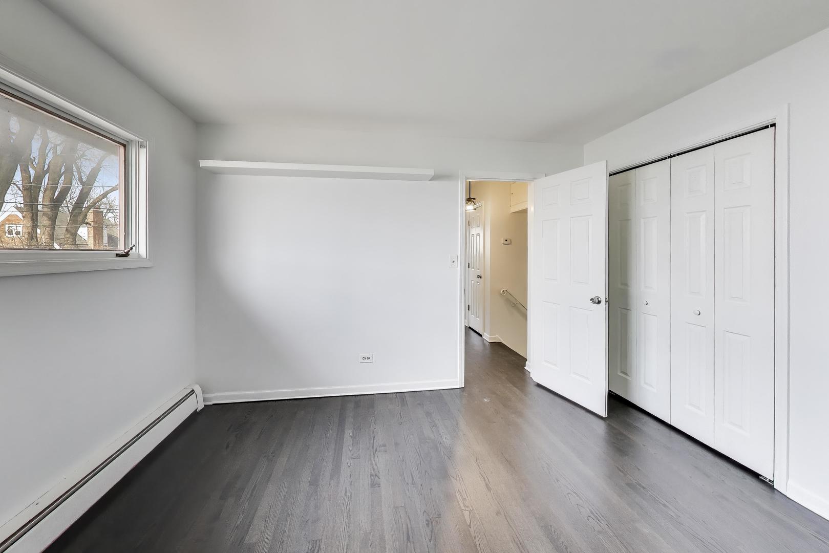 1006 Devon Avenue Park Ridge, IL 60068 - Photo 23 of 38 an empty room with wooden floor and window