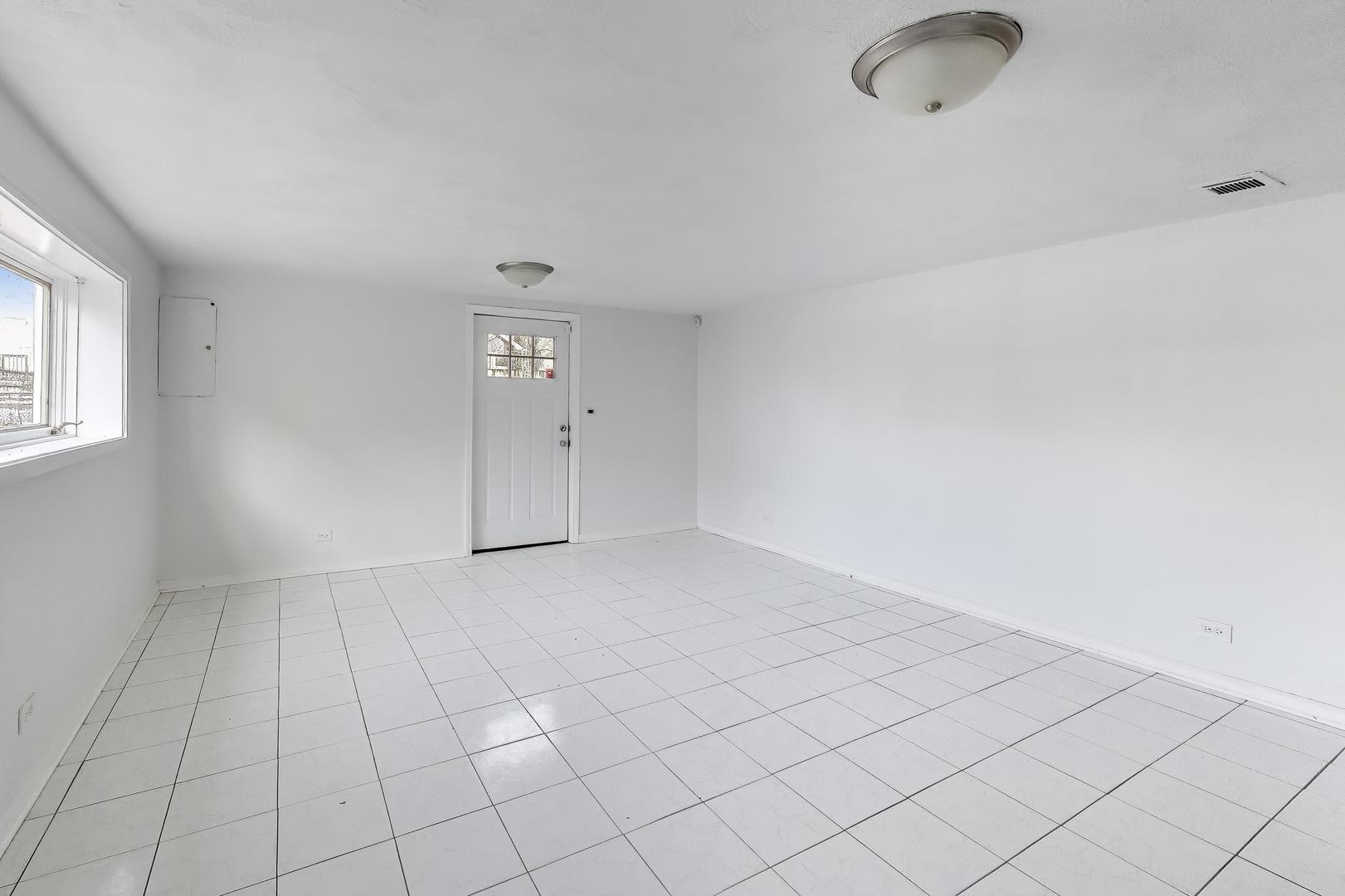 1006 Devon Avenue Park Ridge, IL 60068 - Photo 26 of 38 an empty room with white walls and tiles