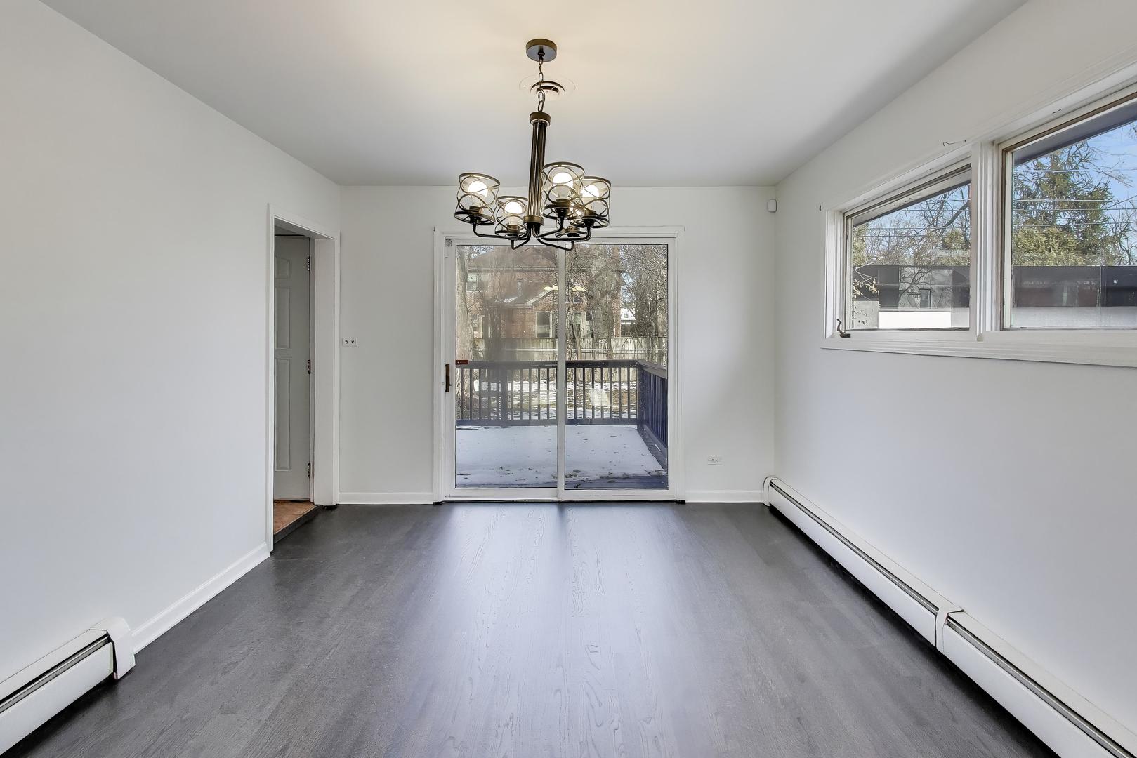 1006 Devon Avenue Park Ridge, IL 60068 - Photo 10 of 38 wooden floor in an empty room with a window