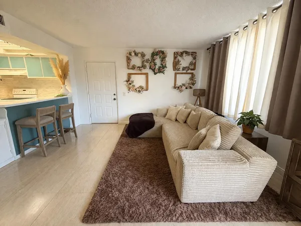 a living room with furniture and a large window