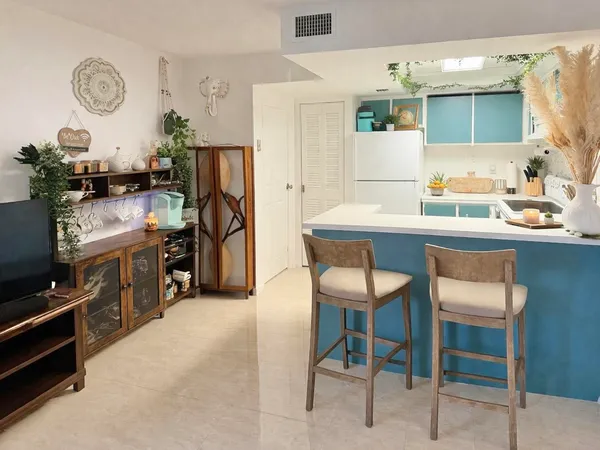 a kitchen with stainless steel appliances kitchen island granite countertop a sink and cabinets