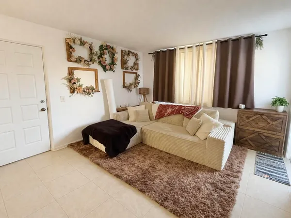 a bedroom with a bed a couch and a window