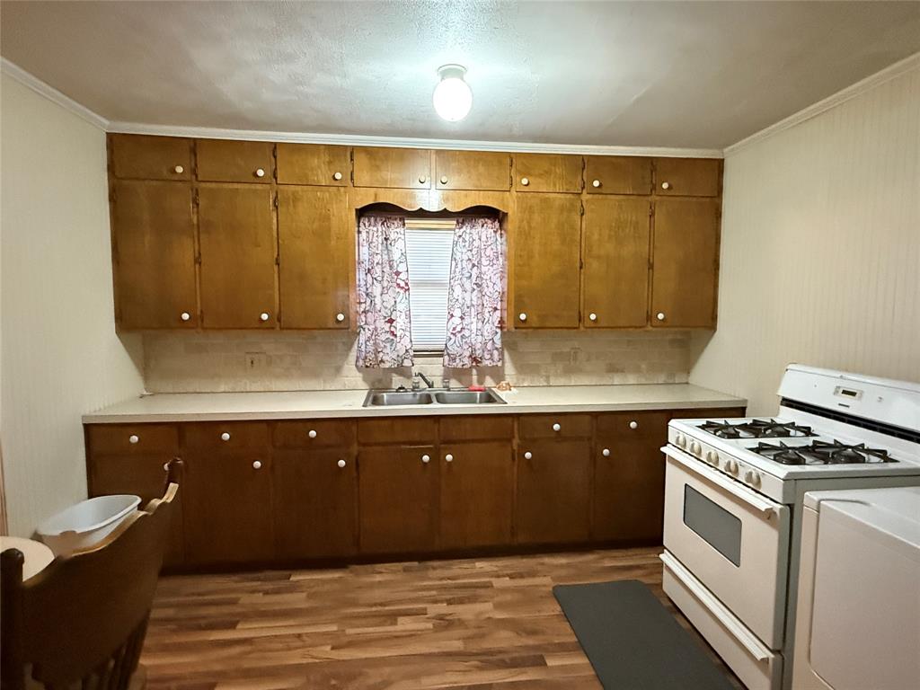 609 East Henry Street Hamilton, TX 76531 - Photo 11 of 40 a kitchen with a sink and cabinets