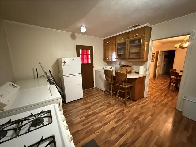 a kitchen with a table and chairs in it
