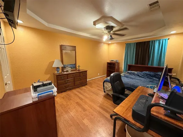 a bedroom with furniture and wooden floor