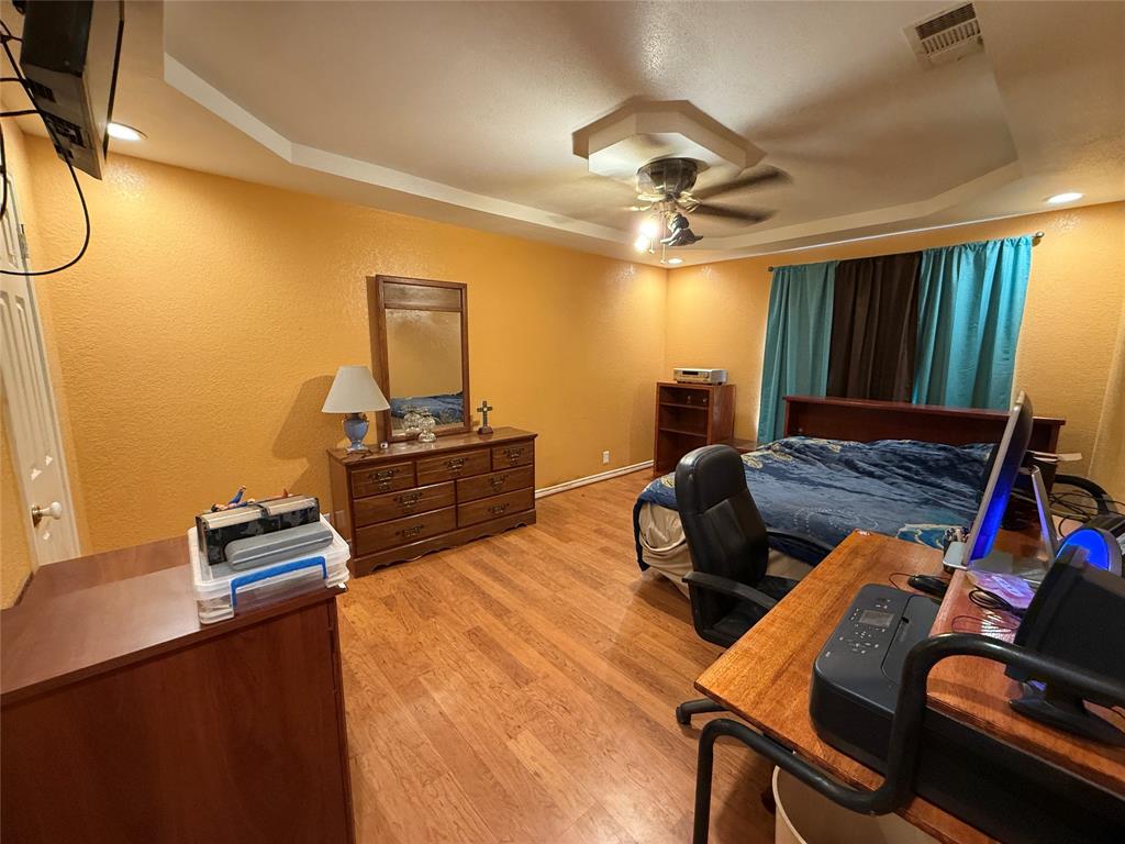 609 East Henry Street Hamilton, TX 76531 - Photo 17 of 40 a bedroom with furniture and wooden floor