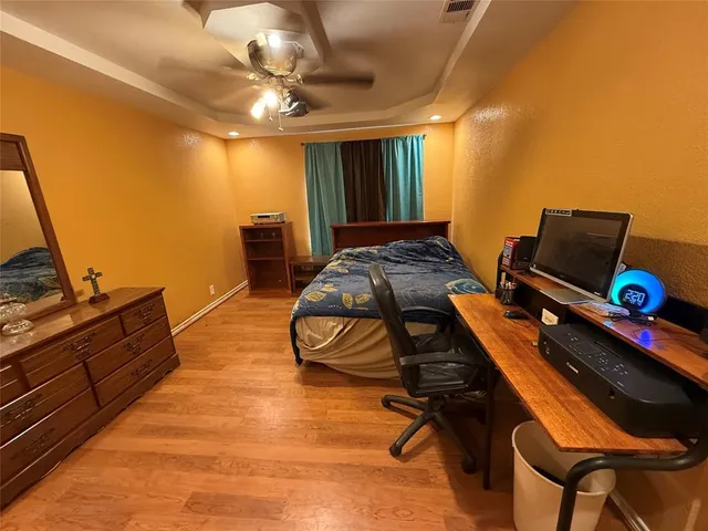 a bedroom with furniture and a dresser