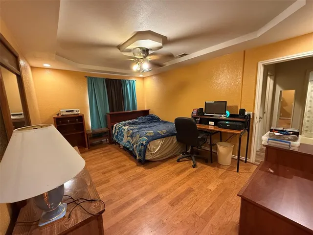 a view of a hallway to a livingroom and a wooden floor