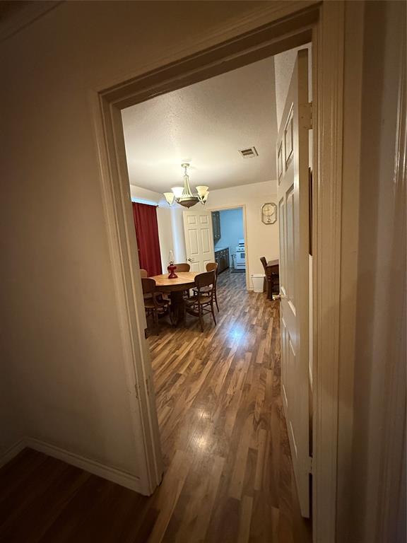 609 East Henry Street Hamilton, TX 76531 - Photo 20 of 40 a view of a hallway to a livingroom and a wooden floor