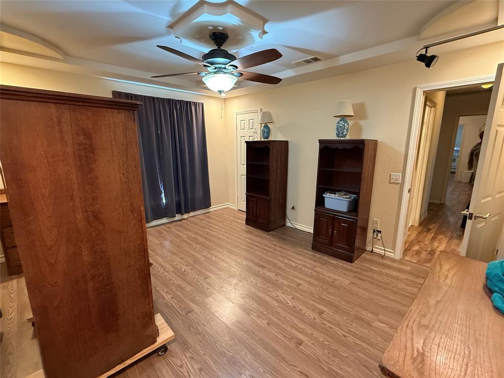 609 East Henry Street Hamilton, TX 76531 - Photo 24 of 40 a view of a kitchen with a refrigerator and a ceiling fan