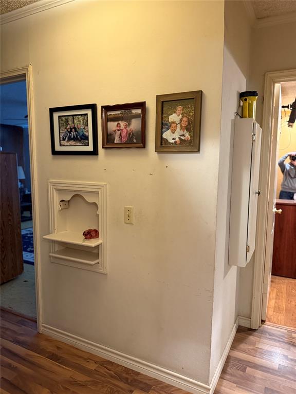 609 East Henry Street Hamilton, TX 76531 - Photo 25 of 40 a view of a hallway with front door and wooden floor