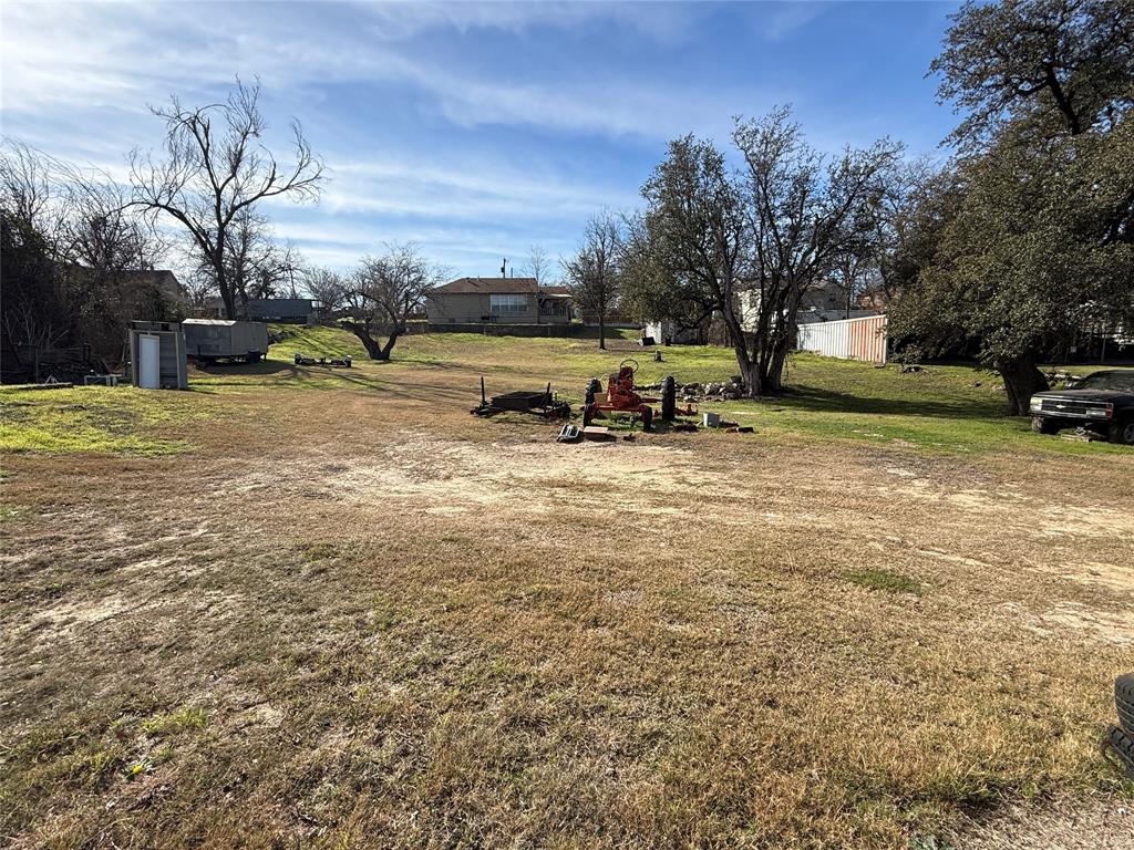 609 East Henry Street Hamilton, TX 76531 - Photo 36 of 40 a view of a yard with a house and in the background