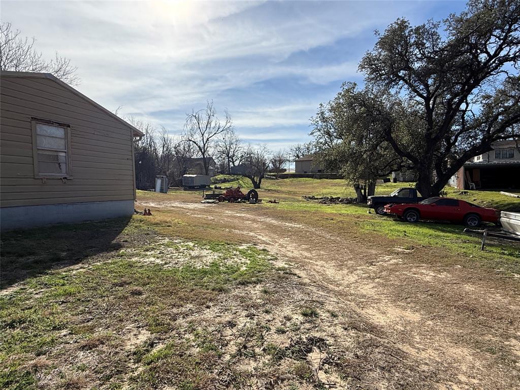 609 East Henry Street Hamilton, TX 76531 - Photo 38 of 40 a view of a street with a building and trees in the background