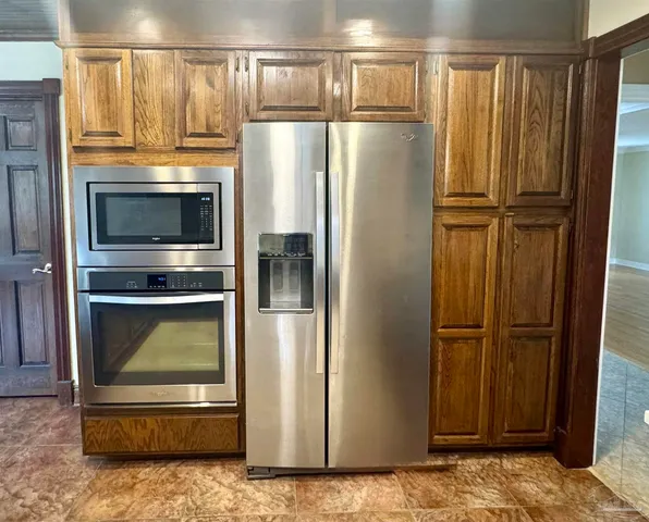 a kitchen with a refrigerator and a stove