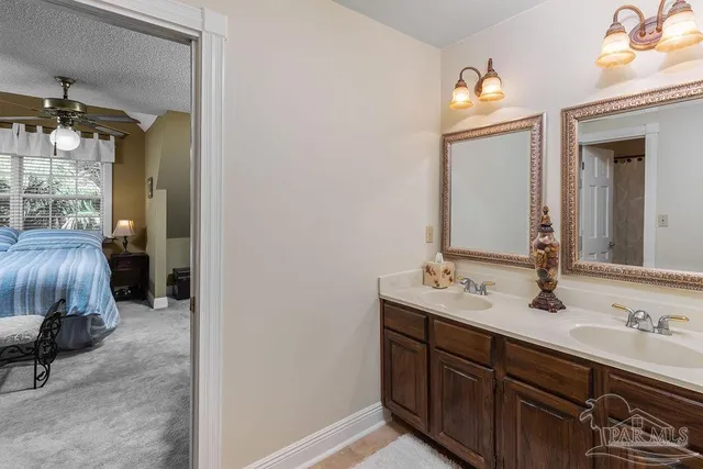 a en suite bathroom with a sink and a mirror