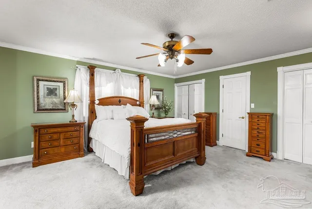 a bed sitting in a room next to a window