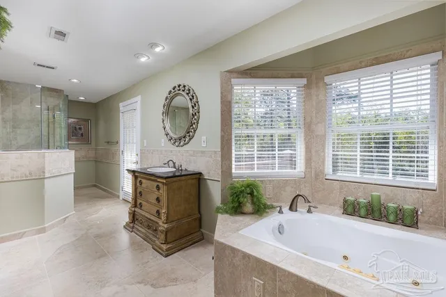 a white bath tub sitting in a bathroom next to a window