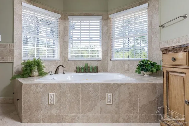 a bathroom with a granite countertop sink a mirror and a vanity