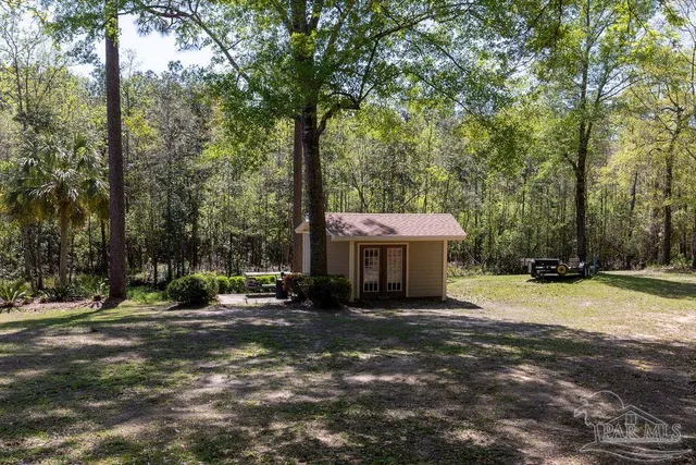 a view of a barn in the middle of a yard