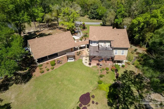 a view of a yard with wooden fence