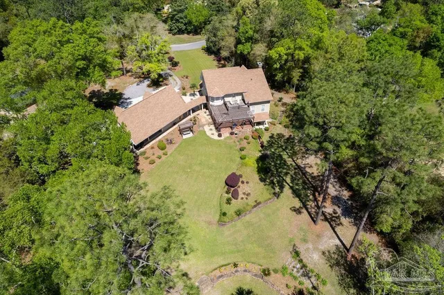 an aerial view of a house with a yard